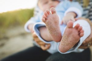 Baby feet with sand on them
